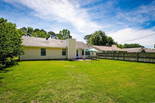 2418 Hickorynut Ct, Little Rock, AR 72211 - rear view of property featuring a patio and a chimney
