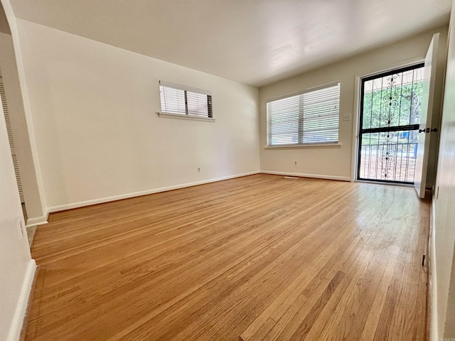 704 W 56th St, North Little Rock, AR 72118 - empty room featuring light wood-style floors and baseboards
