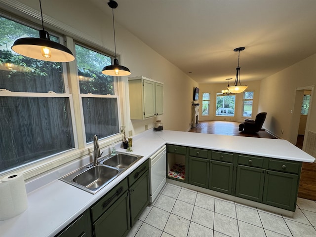 kitchen with green cabinets, a sink, dishwasher, a peninsula, and light tile patterned flooring