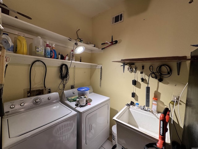 washroom with washer and clothes dryer and a sink