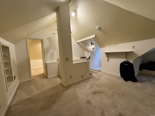 bonus room with vaulted ceiling, carpet, and baseboards
