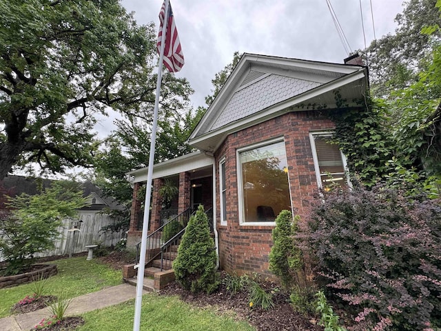 view of front of property with brick siding and a chimney