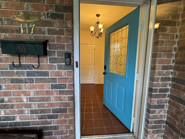 entrance to property featuring brick siding