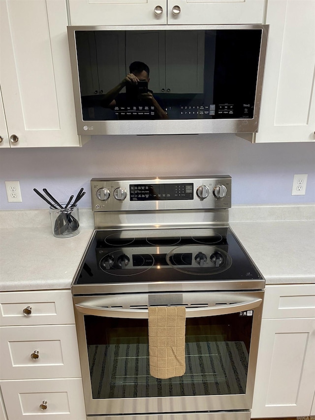 192 Shady Grove, Clarksville, AR 72830 - kitchen view of appliances with stainless steel finishes, light countertops, and white cabinetry
