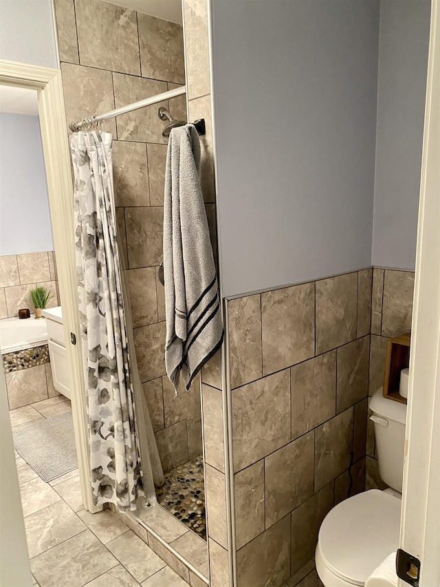 192 Shady Grove, Clarksville, AR 72830 - bathroom with a shower stall, toilet, tile walls, wainscoting, and a garden tub
