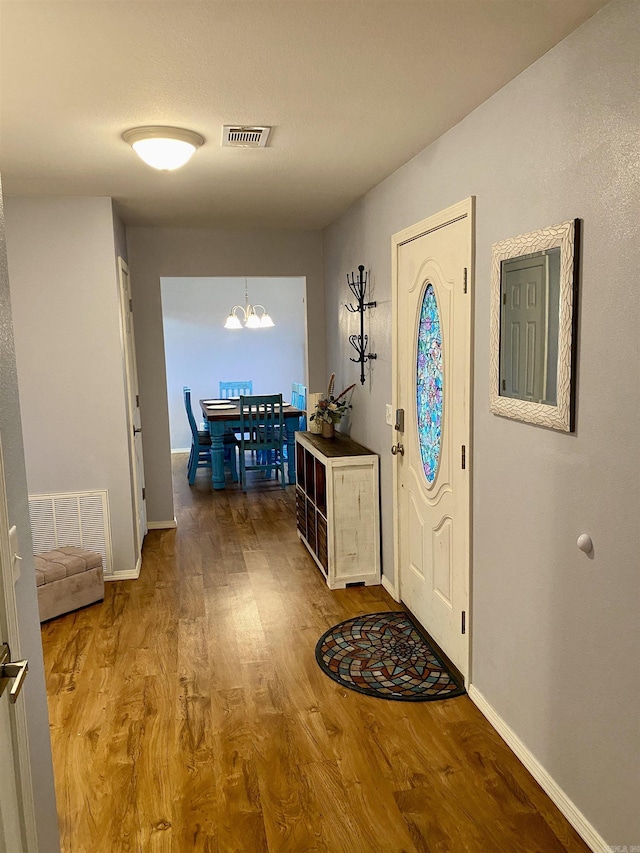 192 Shady Grove, Clarksville, AR 72830 - foyer entrance with wood finished floors, a chandelier, and baseboards