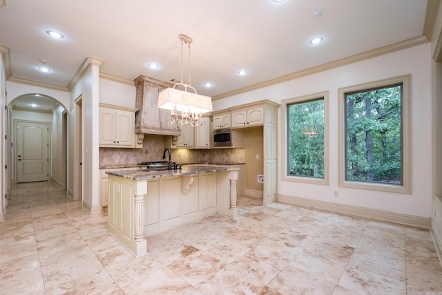 28 Talmont Pl, Little Rock, AR 72223 - kitchen with stainless steel microwave, ornamental molding, light stone countertops, decorative backsplash, and baseboards