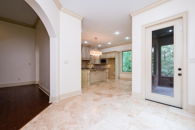 28 Talmont Pl, Little Rock, AR 72223 - kitchen with ornamental molding, stainless steel microwave, baseboards, arched walkways, and a sink