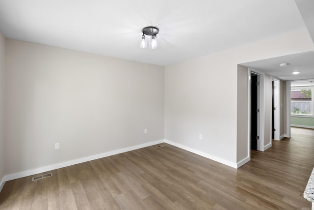 unfurnished room featuring wood finished floors and baseboards