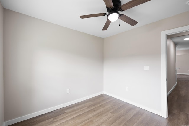 unfurnished room featuring wood finished floors, baseboards, and ceiling fan