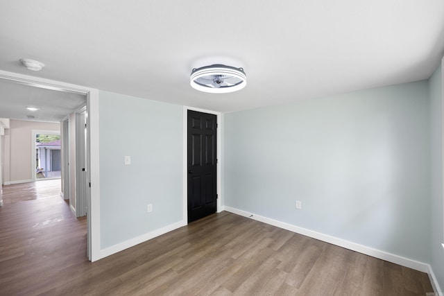 unfurnished bedroom with wood finished floors and baseboards