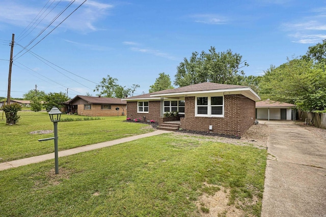 ranch-style house with driveway, brick siding, and a front yard