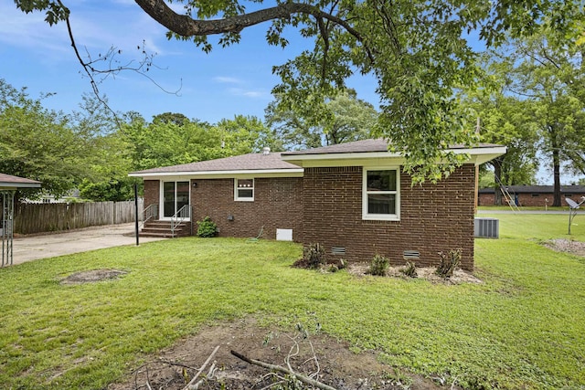 rear view of property with brick siding, crawl space, central air condition unit, entry steps, and a shingled roof