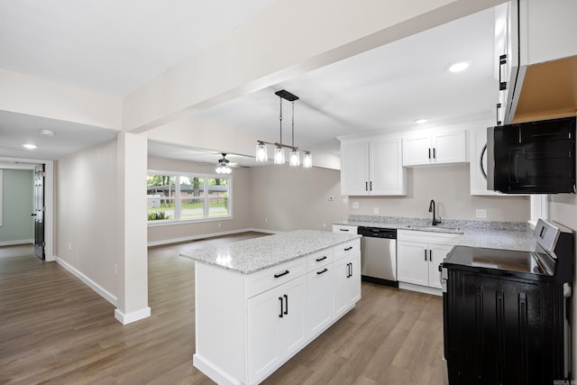 kitchen featuring stainless steel dishwasher, range, black microwave, a sink, and a ceiling fan