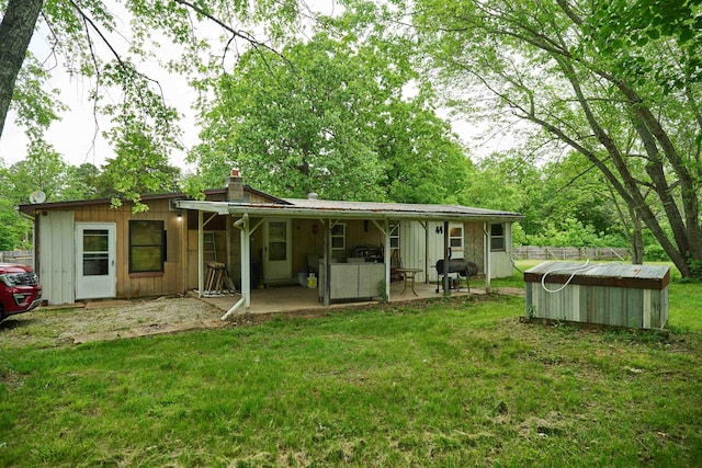 149 Firetower, Hardy, AR 72542 - back of property featuring a patio area, a yard, a chimney, a pool, and board and batten siding