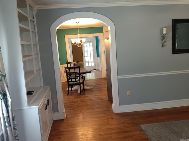 1000 Gum Springs Rd, Searcy, AR 72143 - dining room with arched walkways, a chandelier, wood finished floors, crown molding, and baseboards
