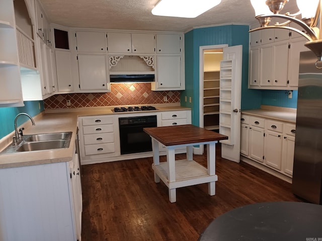 1000 Gum Springs Rd, Searcy, AR 72143 - kitchen with black oven, a sink, freestanding refrigerator, light countertops, and dark wood-style floors