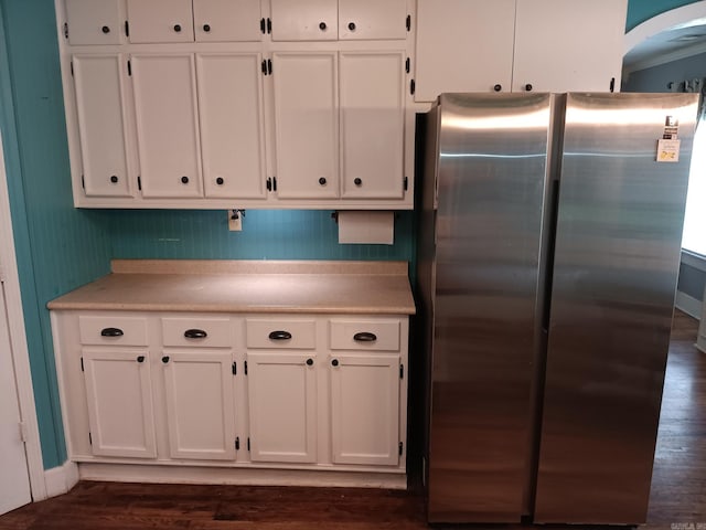 1000 Gum Springs Rd, Searcy, AR 72143 - kitchen featuring freestanding refrigerator, white cabinetry, light countertops, dark wood finished floors, and arched walkways