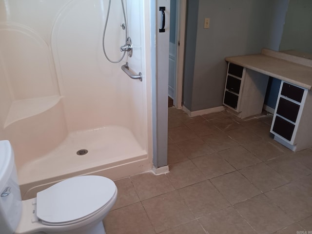 1000 Gum Springs Rd, Searcy, AR 72143 - bathroom featuring tile patterned flooring, a shower stall, toilet, and baseboards