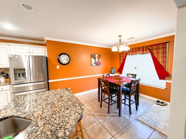 6 Palmer Ct, Searcy, AR 72143 - dining room with a chandelier, crown molding, light tile patterned flooring, and baseboards