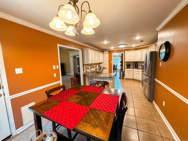 6 Palmer Ct, Searcy, AR 72143 - dining space with a chandelier, ornate columns, crown molding, light tile patterned floors, and baseboards