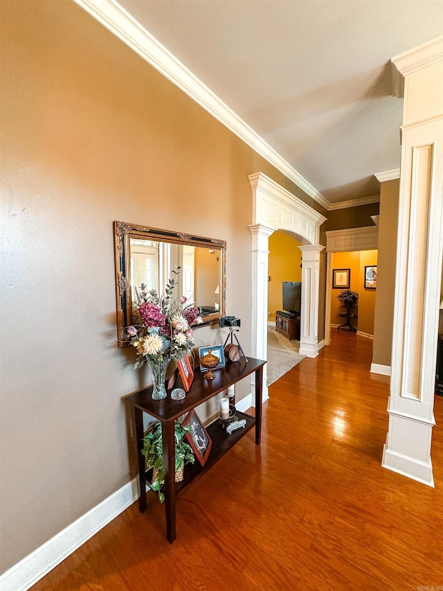 6 Palmer Ct, Searcy, AR 72143 - corridor featuring ornate columns, crown molding, wood finished floors, arched walkways, and baseboards