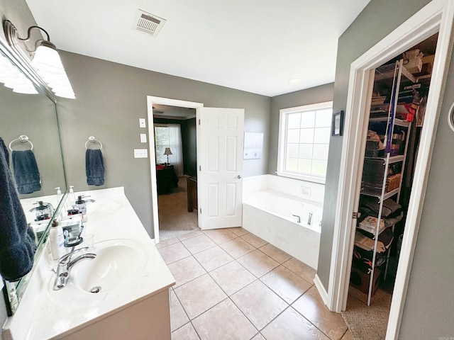 6 Palmer Ct, Searcy, AR 72143 - bathroom featuring a walk in closet, tile patterned flooring, double vanity, and a garden tub