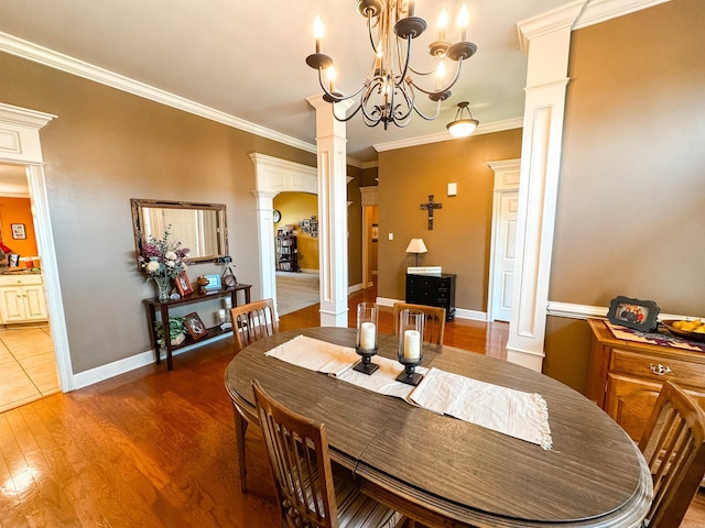 6 Palmer Ct, Searcy, AR 72143 - dining space with ornate columns, light wood-style floors, a chandelier, crown molding, and baseboards