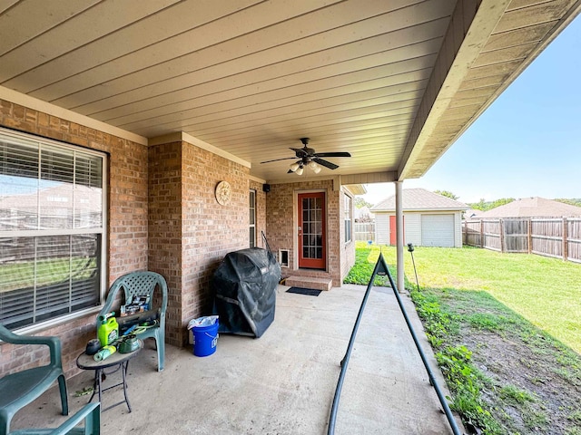 6 Palmer Ct, Searcy, AR 72143 - view of patio with grilling area, a ceiling fan, and an outbuilding