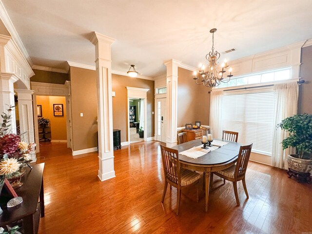 6 Palmer Ct, Searcy, AR 72143 - dining area with decorative columns, wood finished floors, a chandelier, baseboards, and ornamental molding