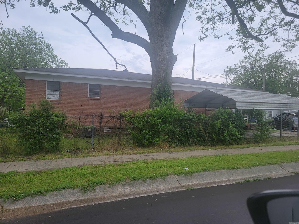801 E 16th St, North Little Rock, AR 72114 - view of home's exterior featuring brick siding and a detached carport