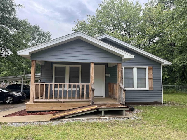 1026 Wilson St, Malvern, AR 72104 - view of front facade with a carport, a front yard, and covered porch