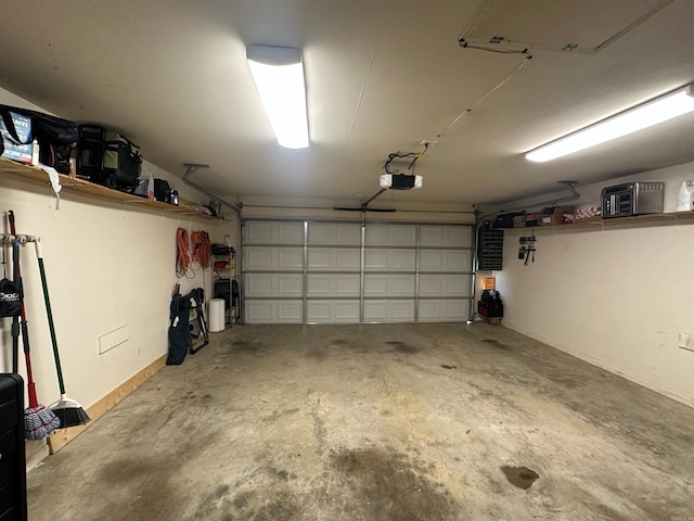 12548 Birch Glen Cv, Alexander, AR 72002 - garage with a garage door opener and baseboards