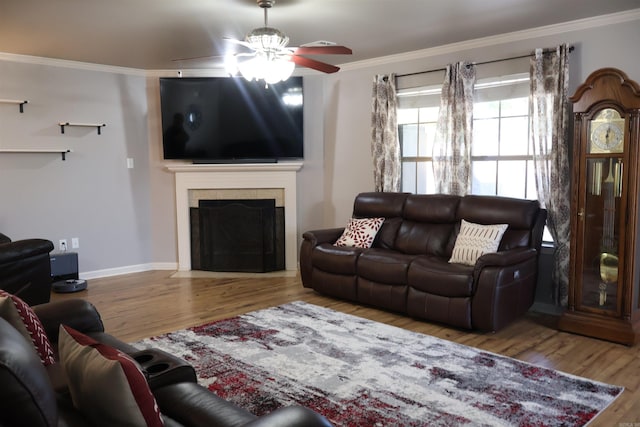 12548 Birch Glen Cv, Alexander, AR 72002 - living room with ceiling fan, ornamental molding, wood finished floors, a tiled fireplace, and baseboards