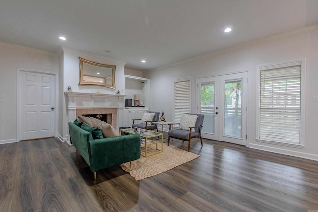 10 Silverwood Ct, North Little Rock, AR 72116 - living area featuring ornamental molding, dark wood-style floors, a tile fireplace, french doors, and recessed lighting