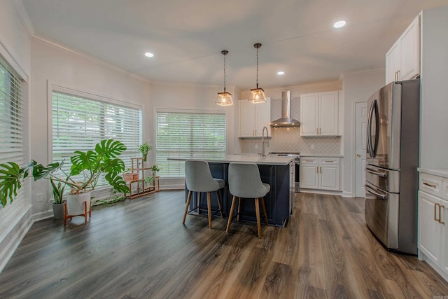 10 Silverwood Ct, North Little Rock, AR 72116 - kitchen with stainless steel appliances, wall chimney range hood, light countertops, white cabinets, and dark wood-type flooring