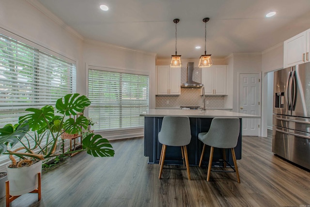 10 Silverwood Ct, North Little Rock, AR 72116 - kitchen with stainless steel fridge, wall chimney range hood, light countertops, white cabinets, and dark wood-type flooring
