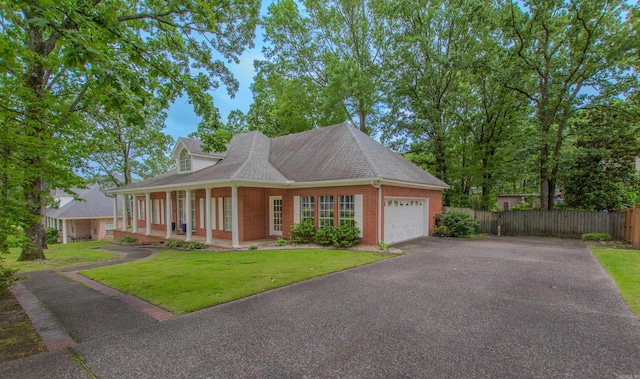 10 Silverwood Ct, North Little Rock, AR 72116 - view of front of home featuring a garage, asphalt driveway, brick siding, a porch, and roof with shingles