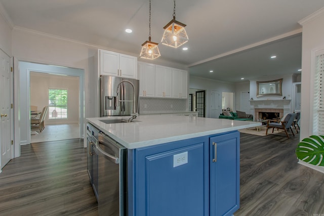 10 Silverwood Ct, North Little Rock, AR 72116 - kitchen with blue cabinetry, appliances with stainless steel finishes, ornamental molding, white cabinets, and dark wood-type flooring