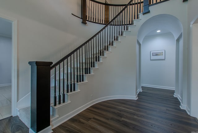 10 Silverwood Ct, North Little Rock, AR 72116 - stairs featuring wood finished floors, arched walkways, baseboards, and a high ceiling
