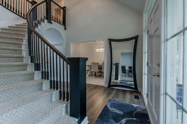 10 Silverwood Ct, North Little Rock, AR 72116 - foyer entrance featuring stairway, wood finished floors, healthy amount of natural light, a chandelier, and a high ceiling