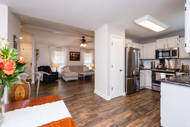 1520 Calgary Cv, Little Rock, AR 72211 - kitchen featuring appliances with stainless steel finishes, white cabinets, dark wood-style flooring, open floor plan, and a ceiling fan