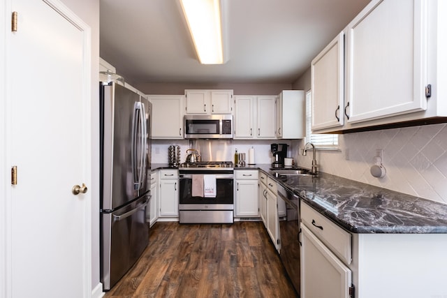 1520 Calgary Cv, Little Rock, AR 72211 - kitchen featuring appliances with stainless steel finishes, a sink, dark wood-style flooring, and white cabinetry