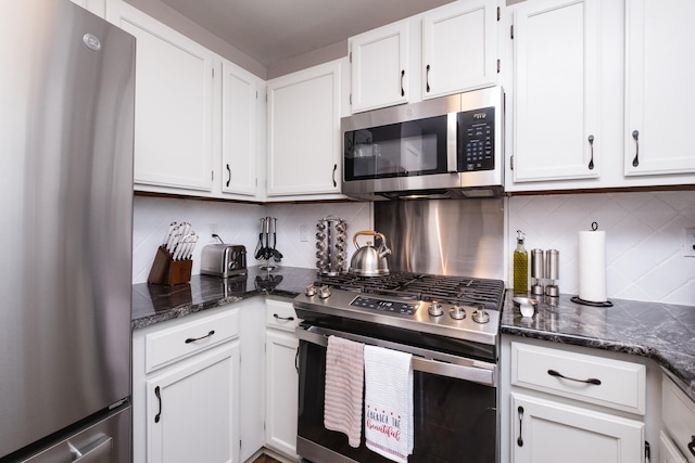 1520 Calgary Cv, Little Rock, AR 72211 - kitchen featuring stainless steel appliances, white cabinets, decorative backsplash, and dark stone counters