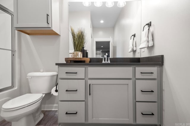 305 W Cross St, Benton, AR 72015 - bathroom featuring toilet, vanity, wood finished floors, baseboards, and recessed lighting
