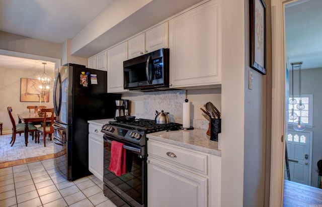 3901 Cedar Hill Rd, Little Rock, AR 72202 - kitchen featuring range with gas stovetop, a chandelier, white cabinetry, tasteful backsplash, and light tile patterned floors