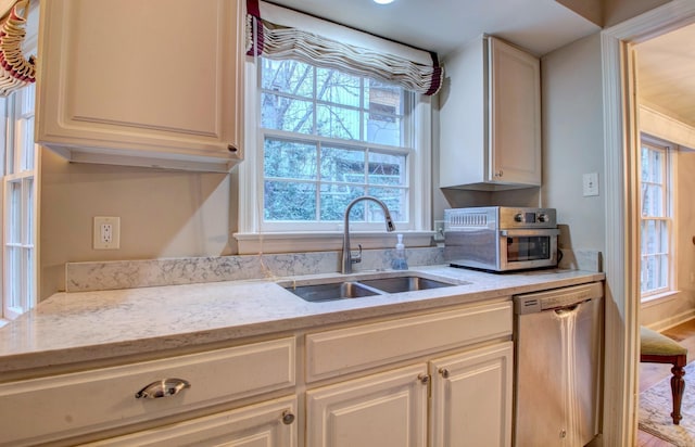 3901 Cedar Hill Rd, Little Rock, AR 72202 - kitchen with stainless steel dishwasher, a sink, healthy amount of natural light, and light stone countertops
