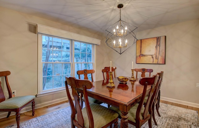 3901 Cedar Hill Rd, Little Rock, AR 72202 - dining space featuring a chandelier, baseboards, and wood finished floors