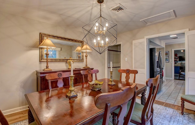 3901 Cedar Hill Rd, Little Rock, AR 72202 - dining area featuring baseboards, a chandelier, and wood finished floors