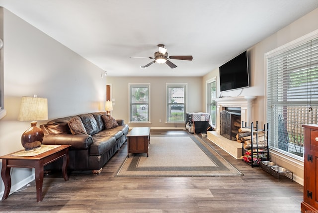 40 High Timber Dr, Maumelle, AR 72113 - living area with ceiling fan, wood finished floors, a fireplace with raised hearth, and baseboards